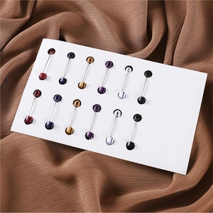 Set of 12 minimalist rhinestone oval headpins on white card over brown textured fabric