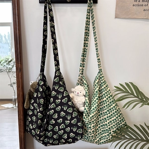 Detail of floral canvas tote bags with green heart and tulip prints in a home setting