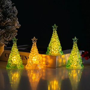 Illuminated crystal-textured mini Christmas trees in green and amber on a reflective base
