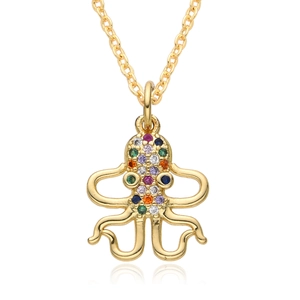 Macro detail of octopus pendant with multi-colored crystals on a gold chain necklace