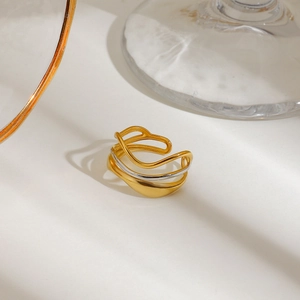 Polished multi-layer wavy ring in gold and silver bicolor finish on white background