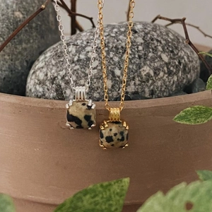 Detail of square Dalmatian Jasper pendant on gold and silver minimalist necklaces