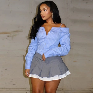 Off-shoulder striped light blue long sleeve shirt with grey pleated mini skirt