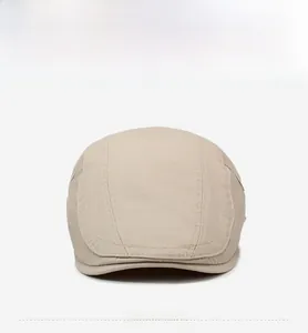 Front view of beige cotton flat cap with triple stitching details and retro style