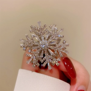 Macro shot of silver rotating snowflake brooch with sparkling cubic zirconia crystals