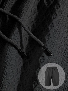 Detail of black waffle knit texture on men's casual sports shorts with drawstring