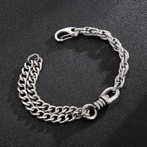 Detail of silver titanium steel bracelet with asymmetric double cuban and textured links