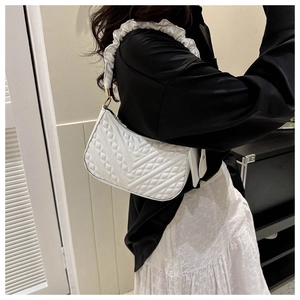 Close-up of a white quilted PU shoulder bag with pleated straps and gold hardware