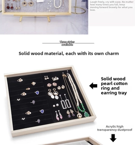 Macro detail of solid wood jewelry organizer with acrylic cover and black foam lining
