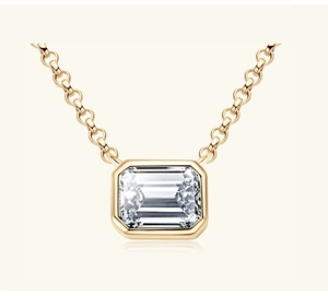 Macro shot of S925 silver emerald-cut pendant necklace in polished gold bezel setting