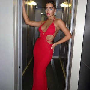Detail of red knit backless dress featuring intricate hollow-out patterns and tie-up neck