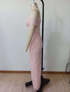 Detailed side view of pink lace off-shoulder evening gown with ruched floral textures
