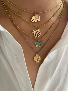 Close-up of colorful enamel animal pendants including elephant and butterfly on gold chains