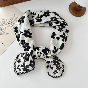 Floral cotton linen scarf with black lace trim and white base in a styled flat lay