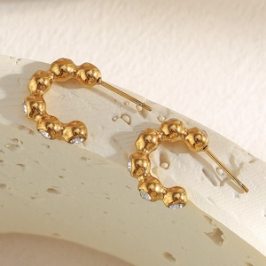 Detail of 18K gold-plated stainless steel hoop earrings with sparkling zircons
