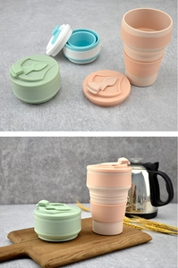 Foldable silicone travel cups in pink, green, and blue-white on a stone background