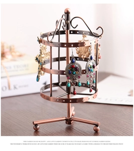 Detail of vintage copper rotating jewelry display stand with three tiers for earrings