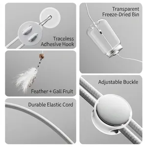Hanging cat puzzle toy with feather charm and clear treat dispenser on elastic rope