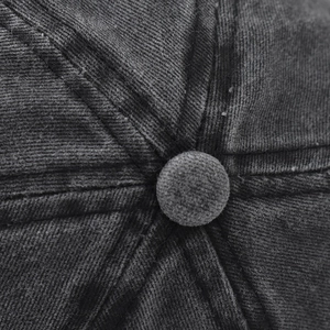 Macro detail of washed denim baseball cap crown showing stitch lines and fabric texture