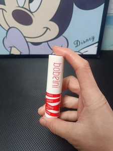 Detailed macro view of bobeini matte lip mud in white packaging with red branding logo