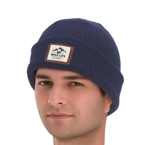 Detail of navy knit beanie featuring a Wild Life Adventures mountain patch on front
