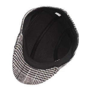 Plaid wool-like flat cap in black and white check pattern with interior lining and size tag