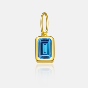 Detailed view of square blue zircon pendant in gold plating with polished finish