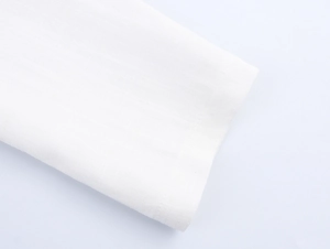 Close-up detail of white linen fabric texture with visible weave on the spring suit coat