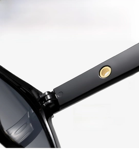 Detail of reinforced metal hinge and gold decor on premium black square sunglasses