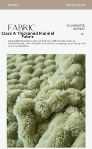 Macro detail of grass green flannel blanket showing thick and soft fabric texture