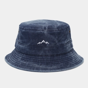 Close-up of mountain peak embroidery and metal eyelets on vintage navy bucket hat
