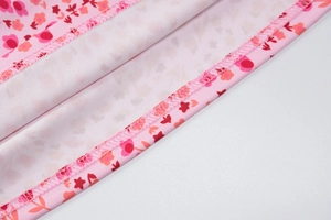 Detail shot of the precise overlock stitching and floral fabric on this summer dress