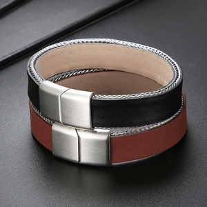 Detail of braided leather bracelets with metallic chain edges and silver magnetic clasps