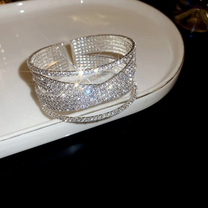 Macro shot of silver crisscross bangle with sparkling zircon and layered open design