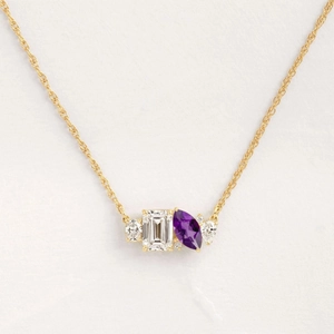 Gold pendant necklace with emerald-cut white stone and marquise-cut purple amethyst