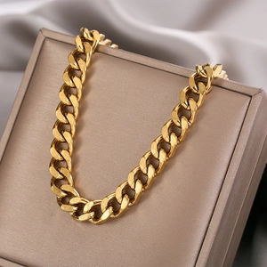 Polished gold cuban link titanium steel chain necklace on luxury jewelry box display