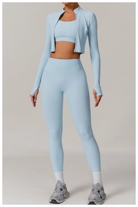 Detailed front view of women's light blue three-piece yoga set with jacket and bra