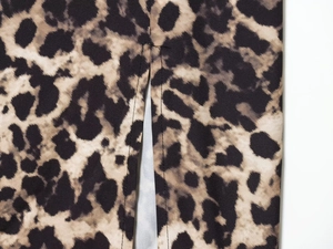 Close-up of leopard print fabric detail showing high-quality stitching and a side slit