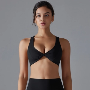 Front twist detail on a black high-elasticity sports bra with a deep neck design