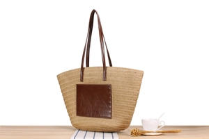 Large straw tote bag on a wooden table with a coffee cup for a casual holiday vibe