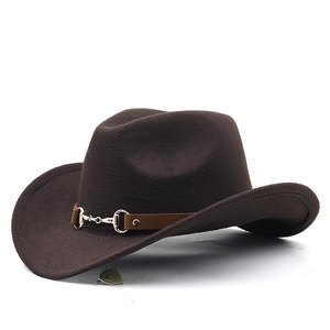 Detail of dark brown wool felt cowboy hat with gold metal buckle and vintage side emblem