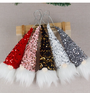 Detail of five sequined Christmas gnome ornaments with plush white beards and wire hooks