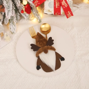 Gnome-themed Christmas cutlery holder with reindeer antlers on a white plate