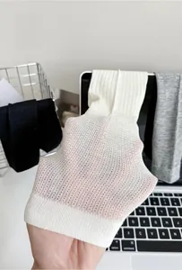 Detailed view of white cotton knit sock showing breathable mesh texture and sheer thin fabric