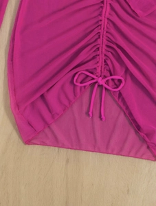 Detail of rose red mesh bikini cover-up featuring ruched drawstring and bow tie detail