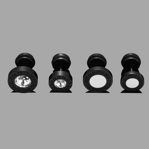 Detail of four black stainless steel stud earrings with Greek meander patterns and zircons