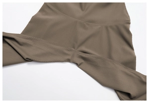 Close-up of ribbed taupe yoga leggings showing high waist cut and reinforced stitching
