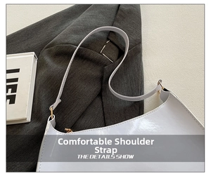 Detail of grey square shoulder bag with smooth synthetic leather and gold metal buckle