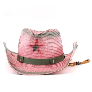 Detailed close-up of pink straw cowboy hat with star emblem and rhinestone band