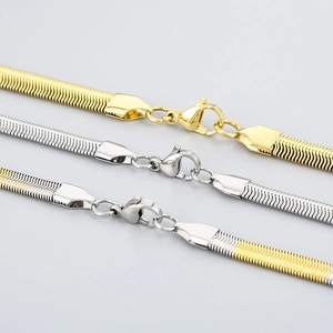 Detailed macro view of gold, silver, and two-tone flat snake chains with lobster clasps